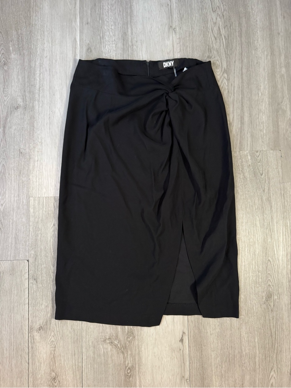 DKNY black midi skirt With a decorative front knot detail and a high slit Sz 12.